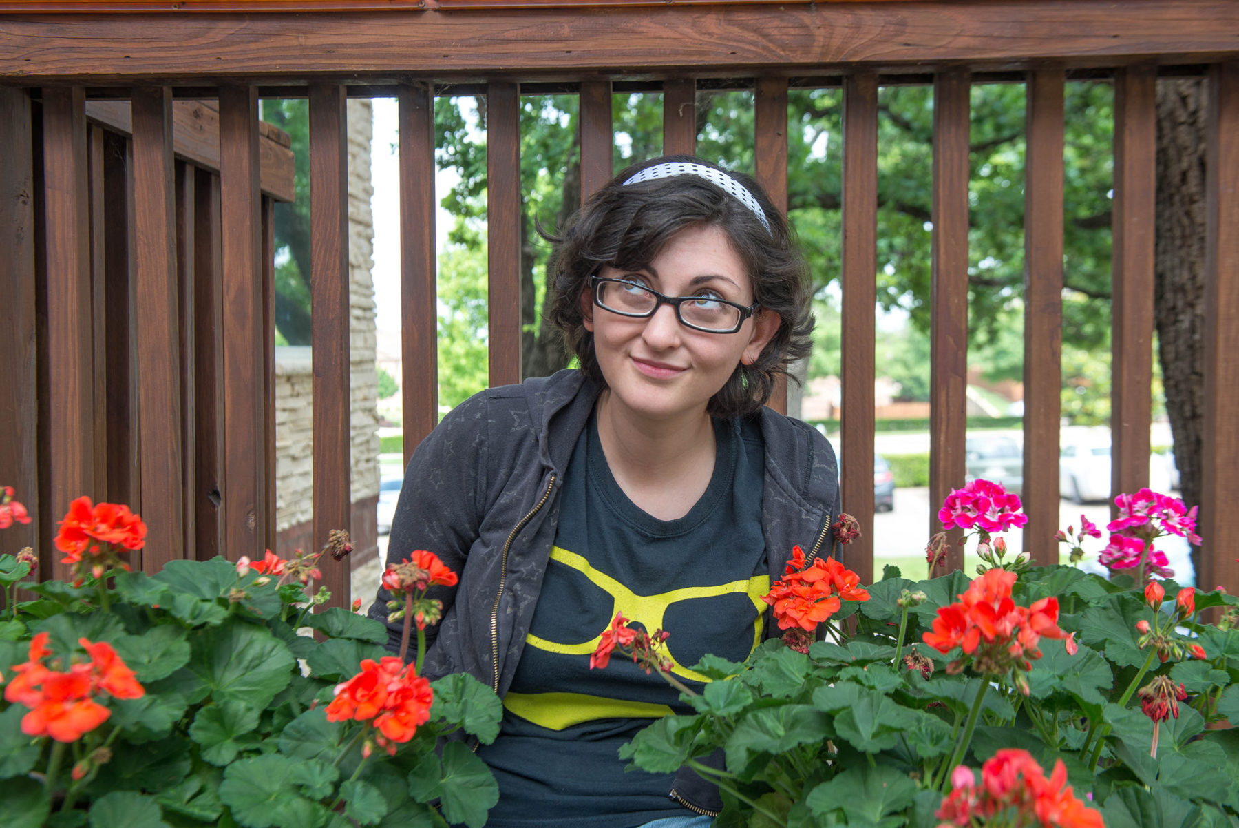 woman sitting in flower bed smiling