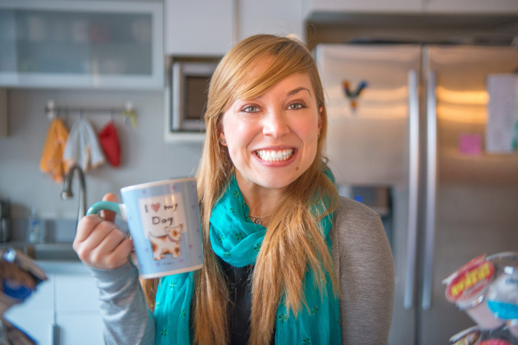 young lady holding a coffee mug that says I love my dog